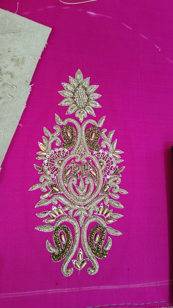 An intricate central motif with curling leaves and a flower-shaped crown.